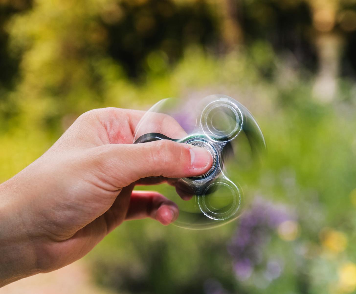 Adult ADHD therapy showing hand spinning a fidget device